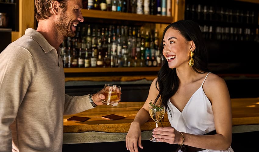 Man and woman chatting at the Stockman bar